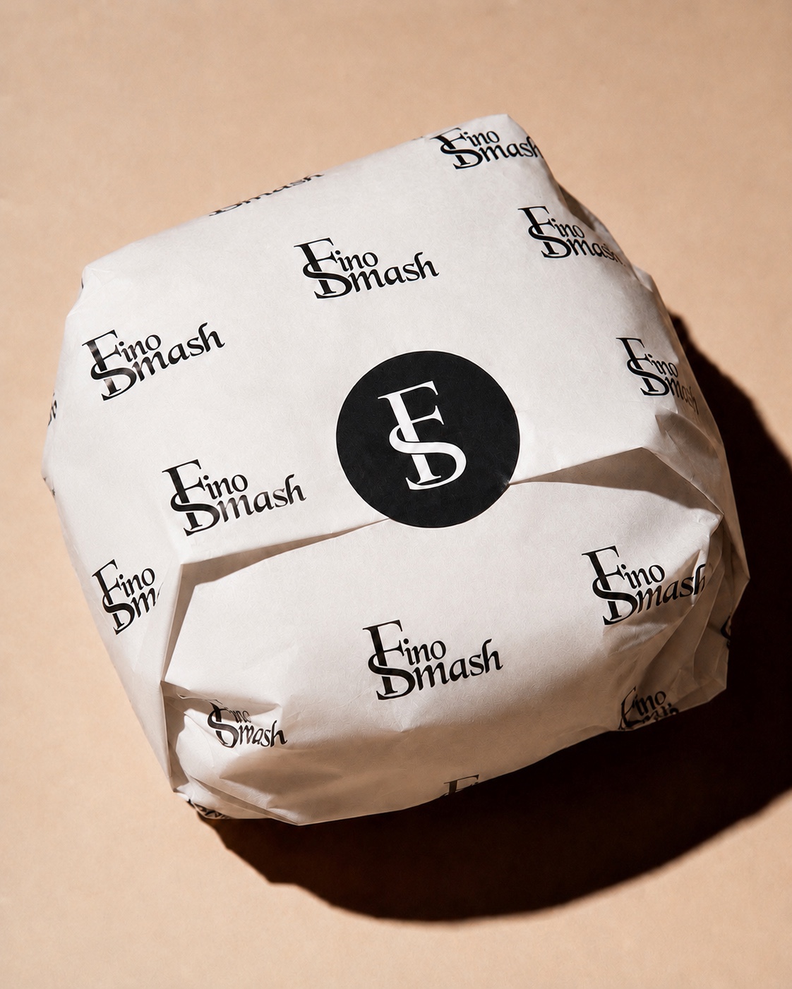 Close detail of the FinoSmash wrapped burger and its circular FS seal